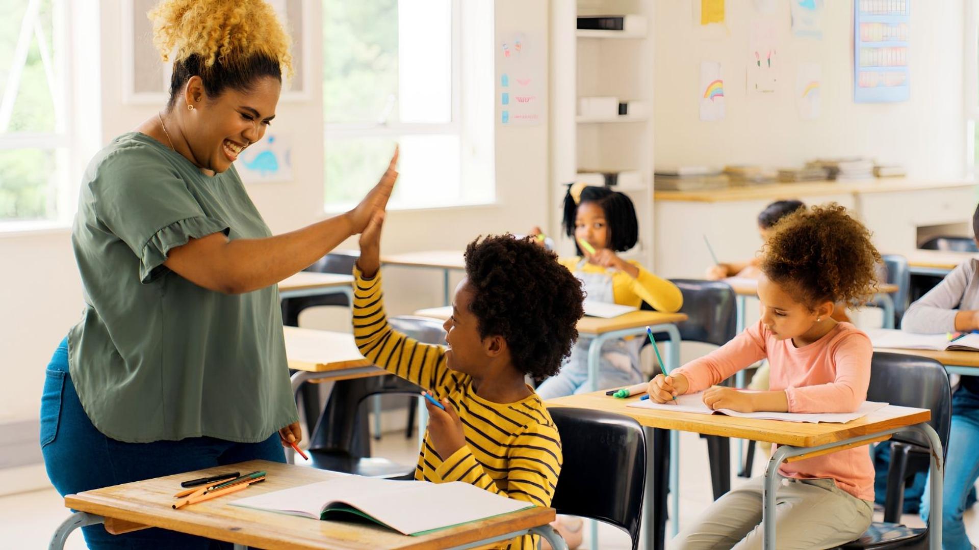 teacher-high-fiving-student-during-class-activity