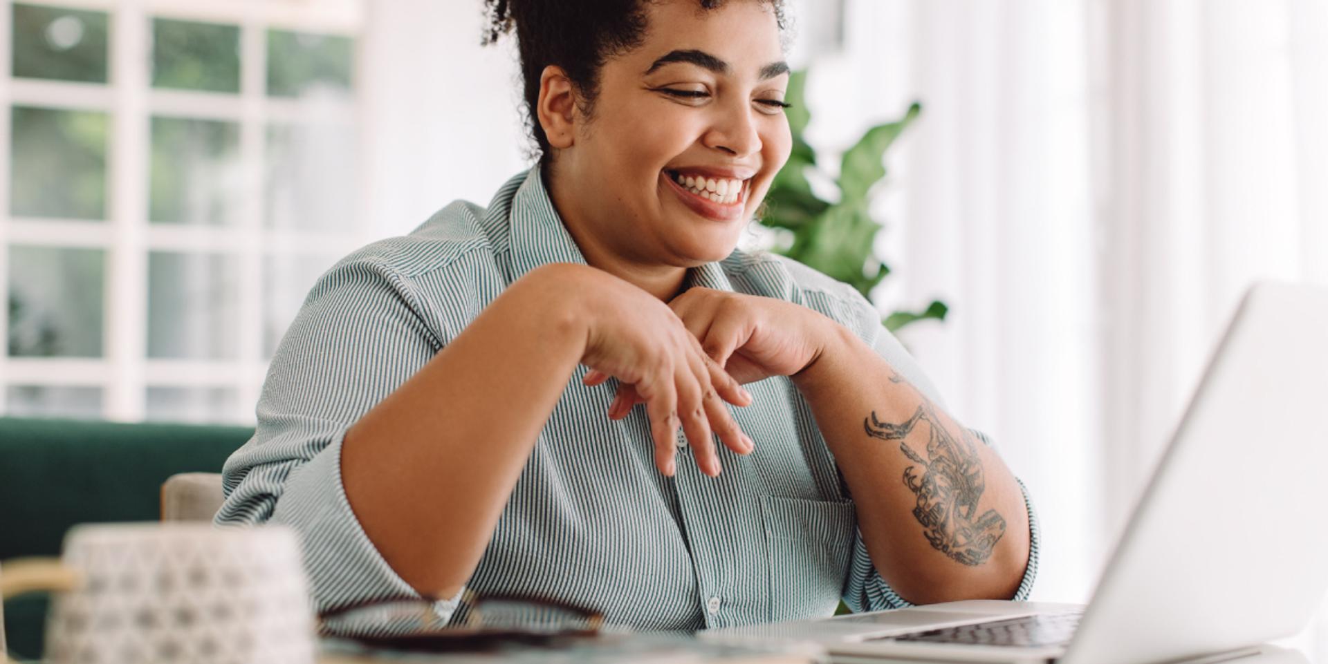person smiling at computer