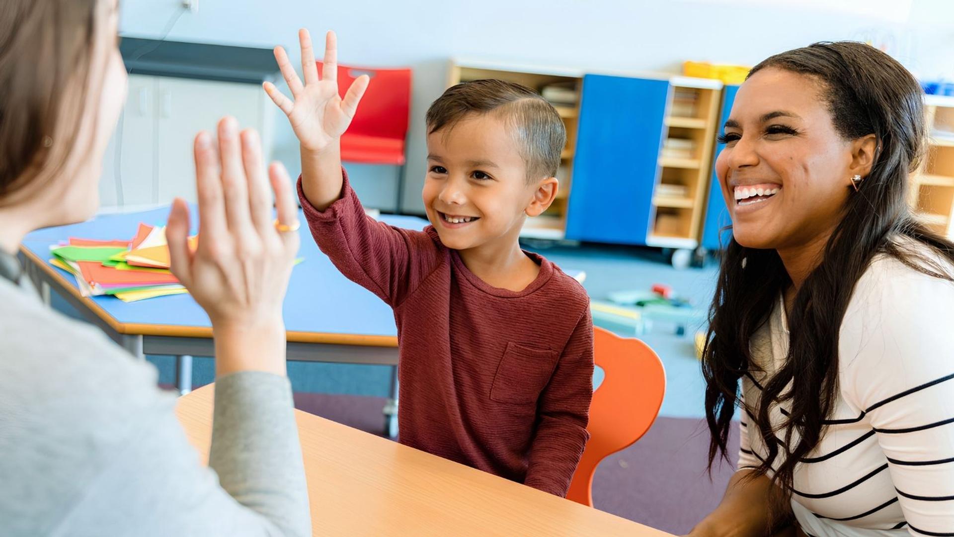 student_high_fiving_teacher