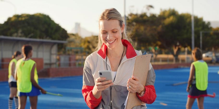 sports coach organizing on phone