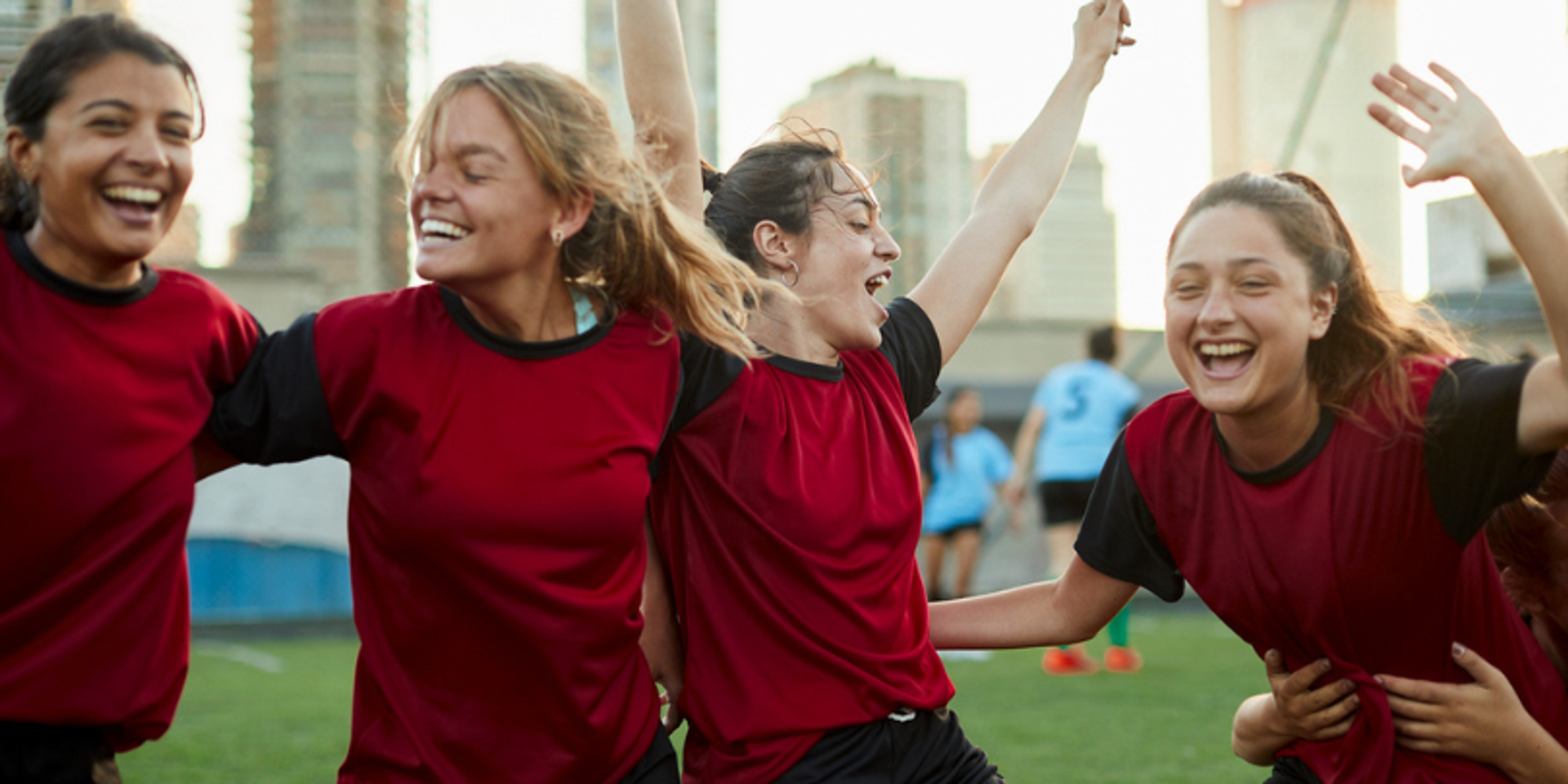 female soccer players laughing