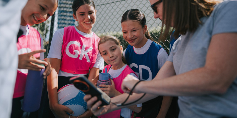parents showing kids phone screen