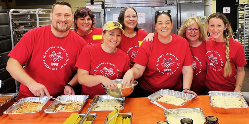 Lasagna love chefs in red shirts prepare lasagna dishes for families.
