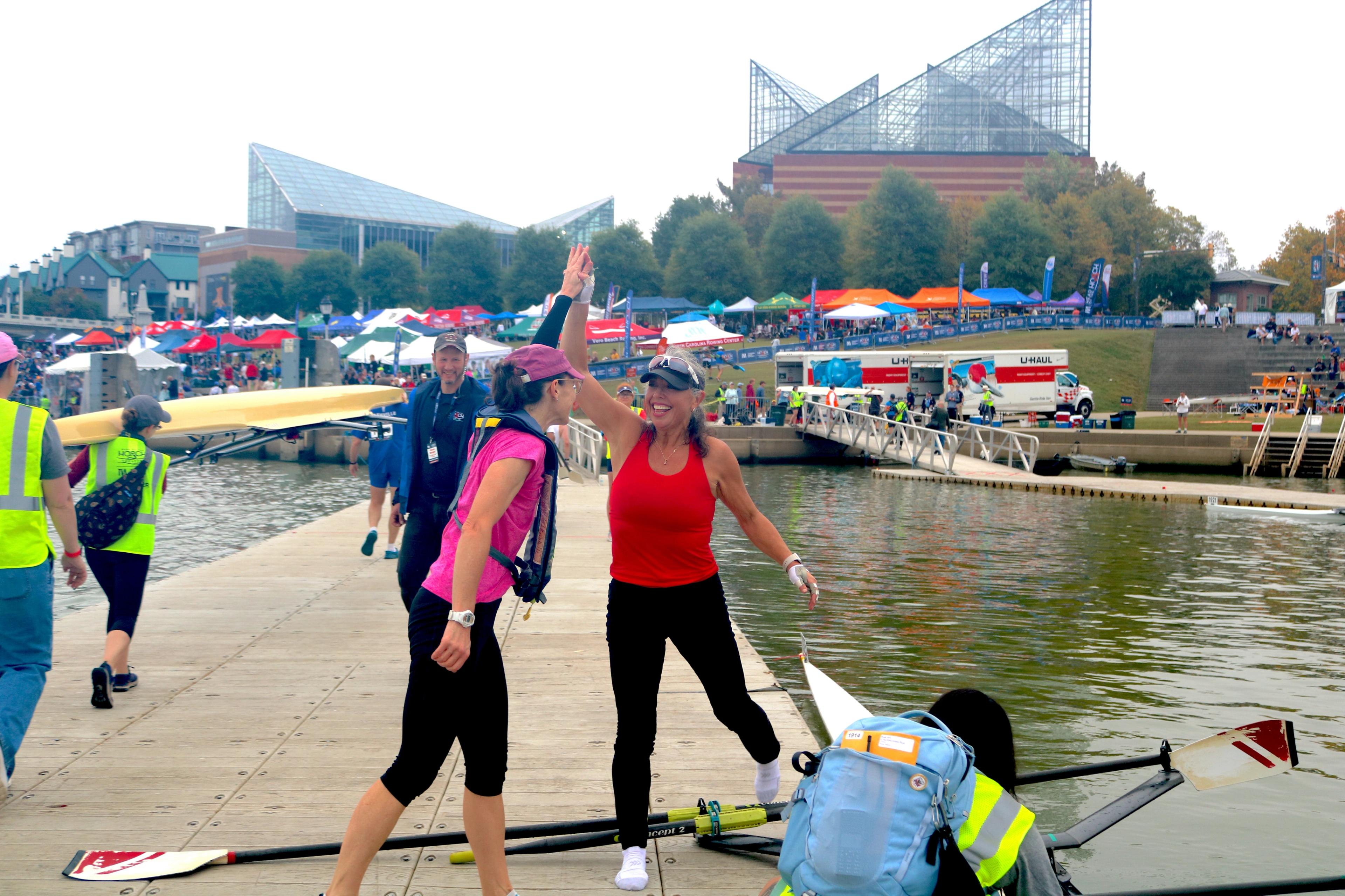 rowers high fiving at head of the hooch regatta