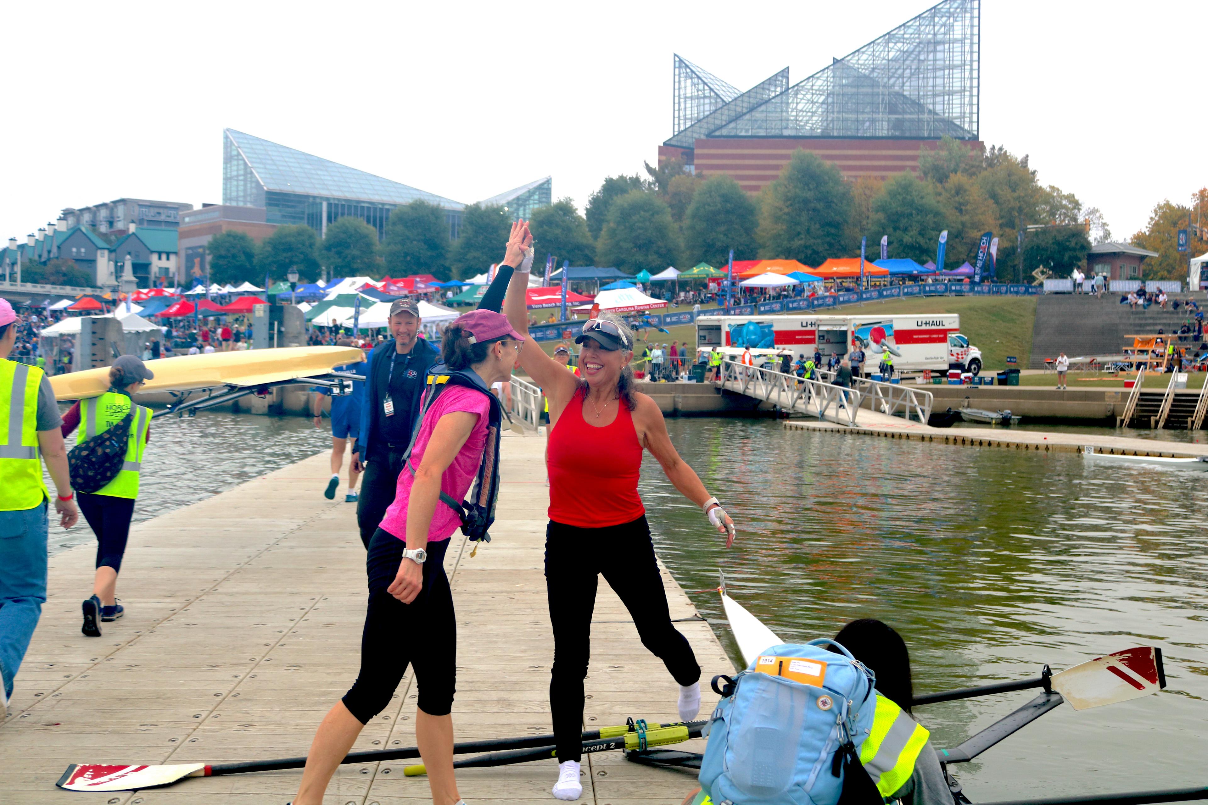 rowers high fiving at head of the hooch regatta