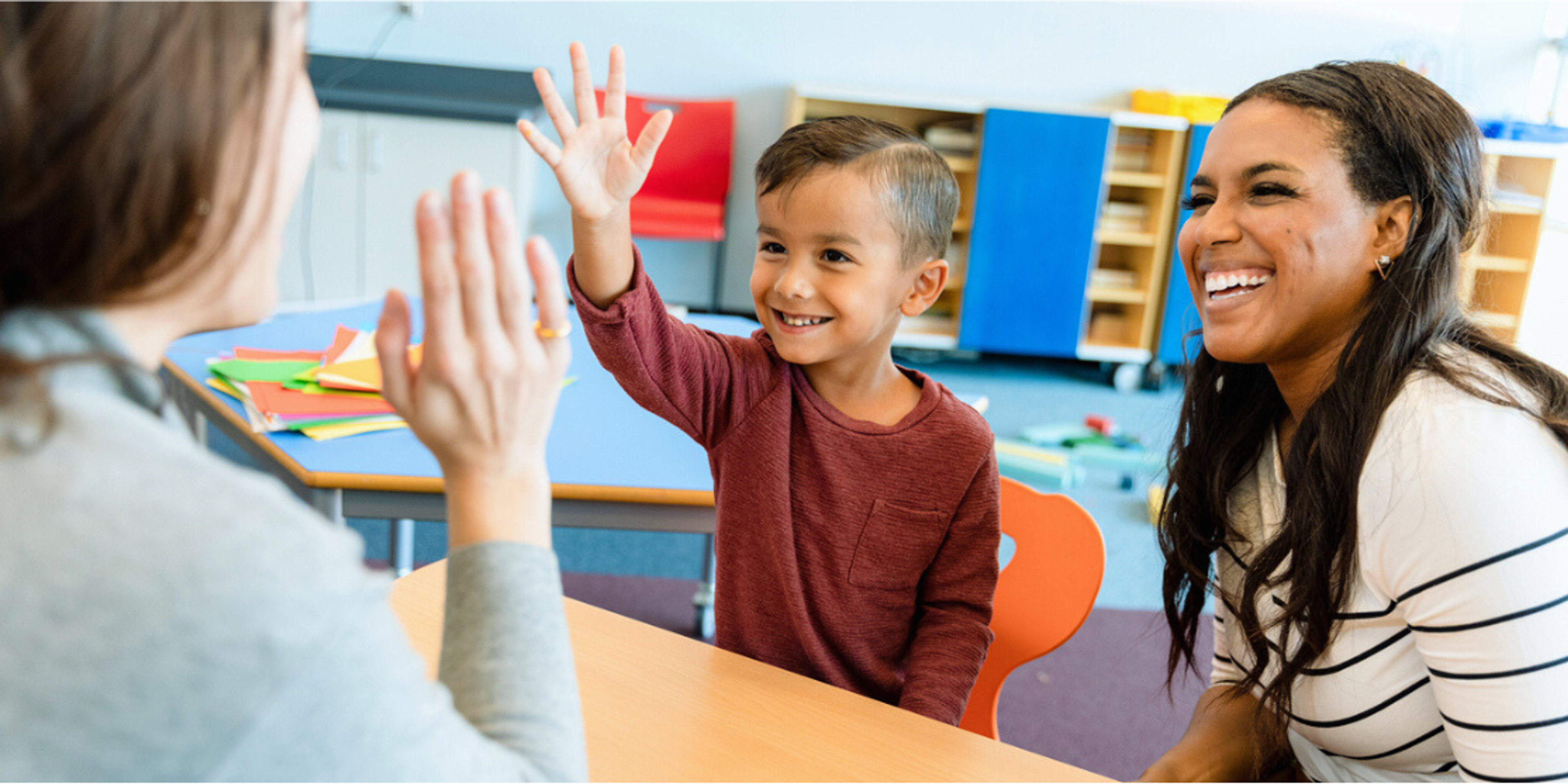 student_high_fiving_teacher