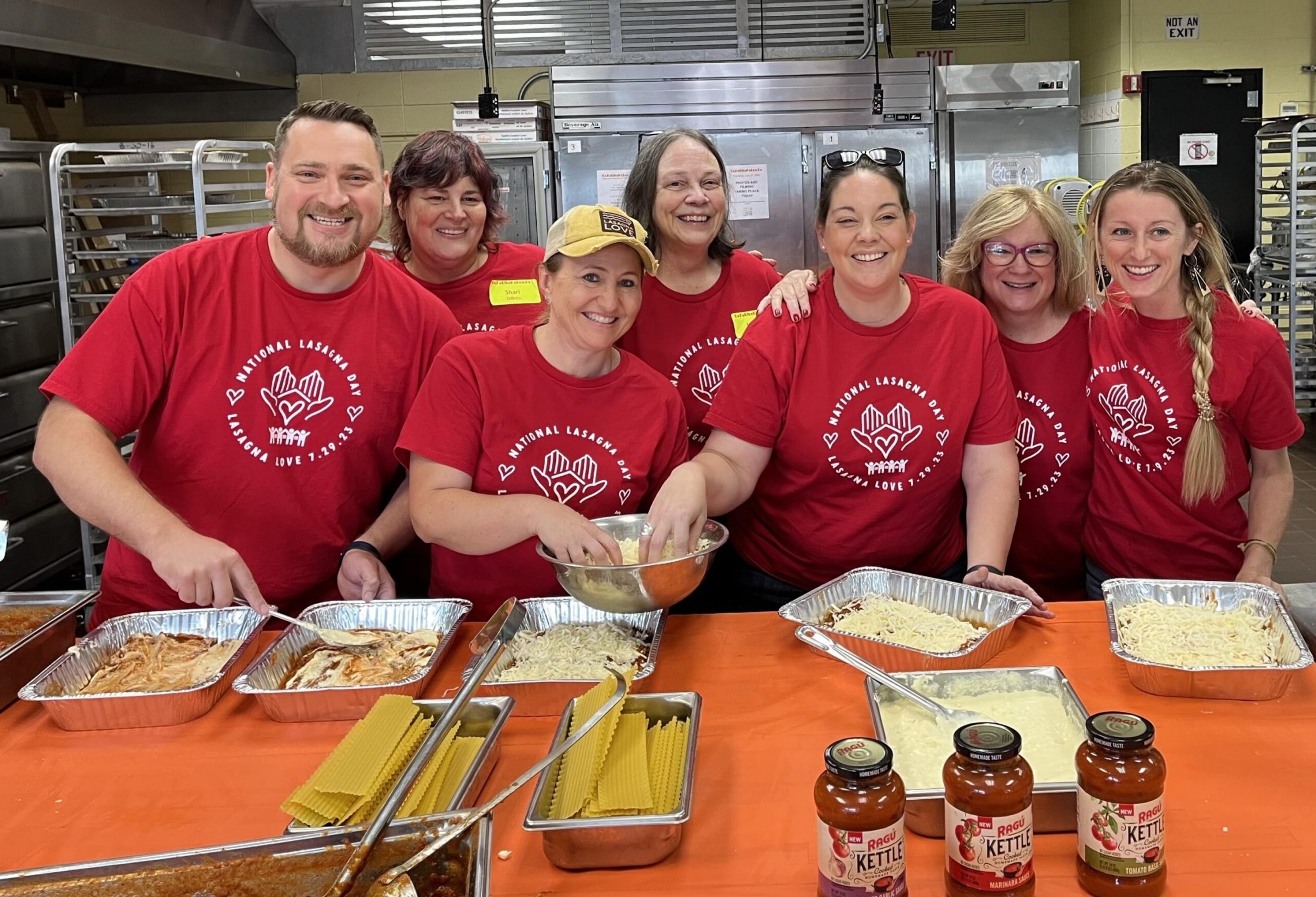 Lasagna love chefs in red shirts prepare lasagna dishes for families.