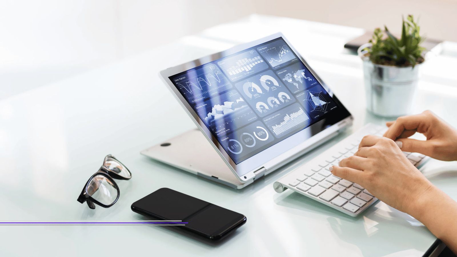 Hands typing at a desk in front of a tablet showing marketing analytics dashboards, featured image from Best Digital Marketing Agencies in Singapore