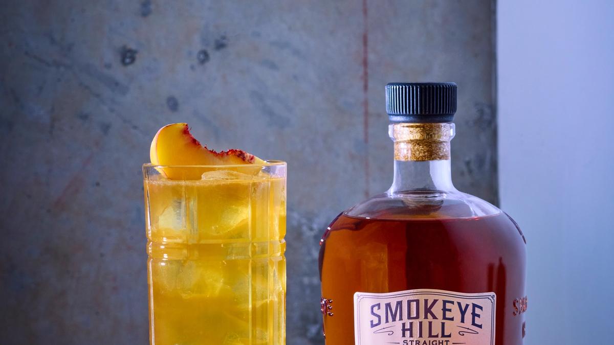 Image of peach tea cocktail on neutral background.