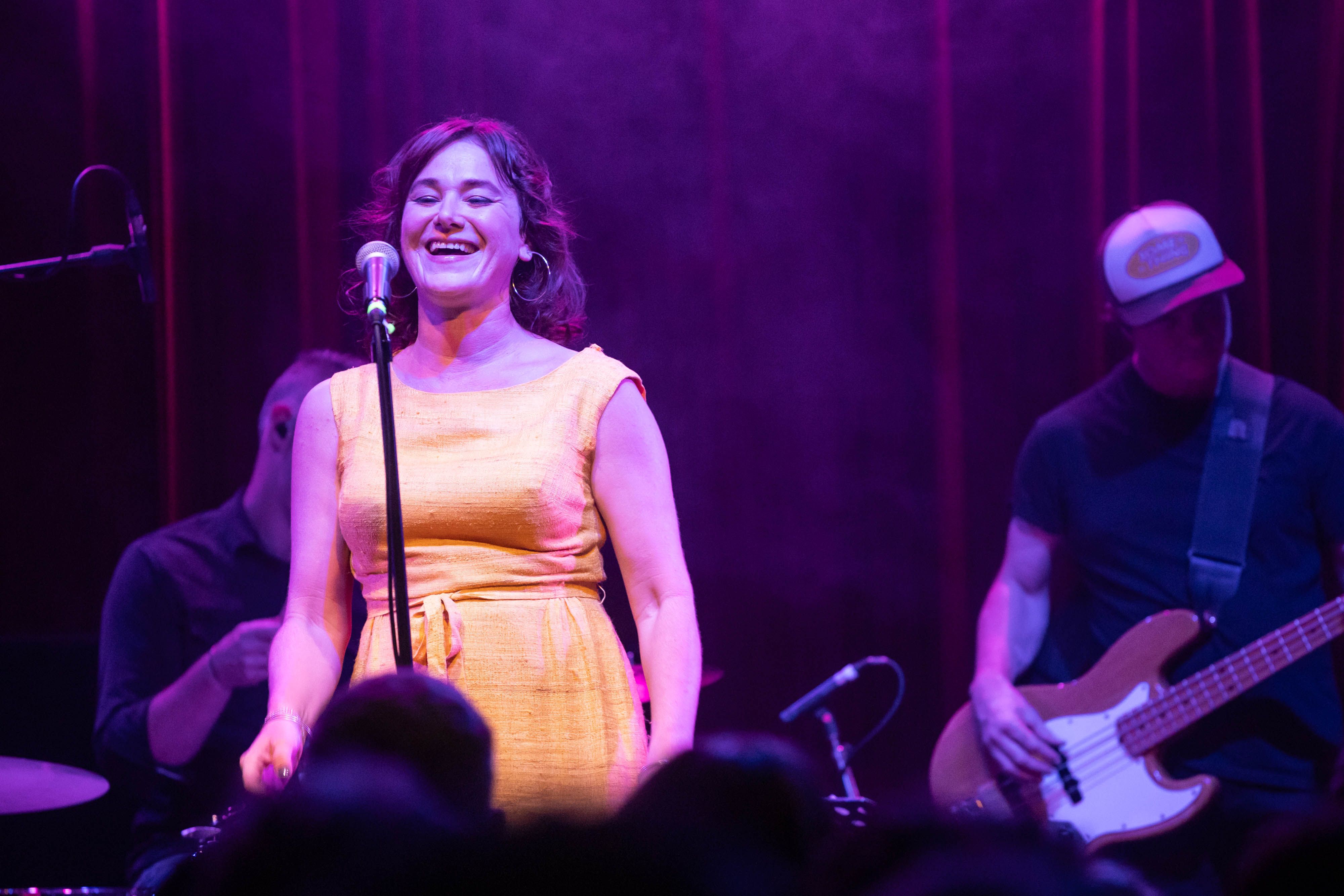 Colleen Rennison smiles as she sings on the stage of the Fox Cabaret