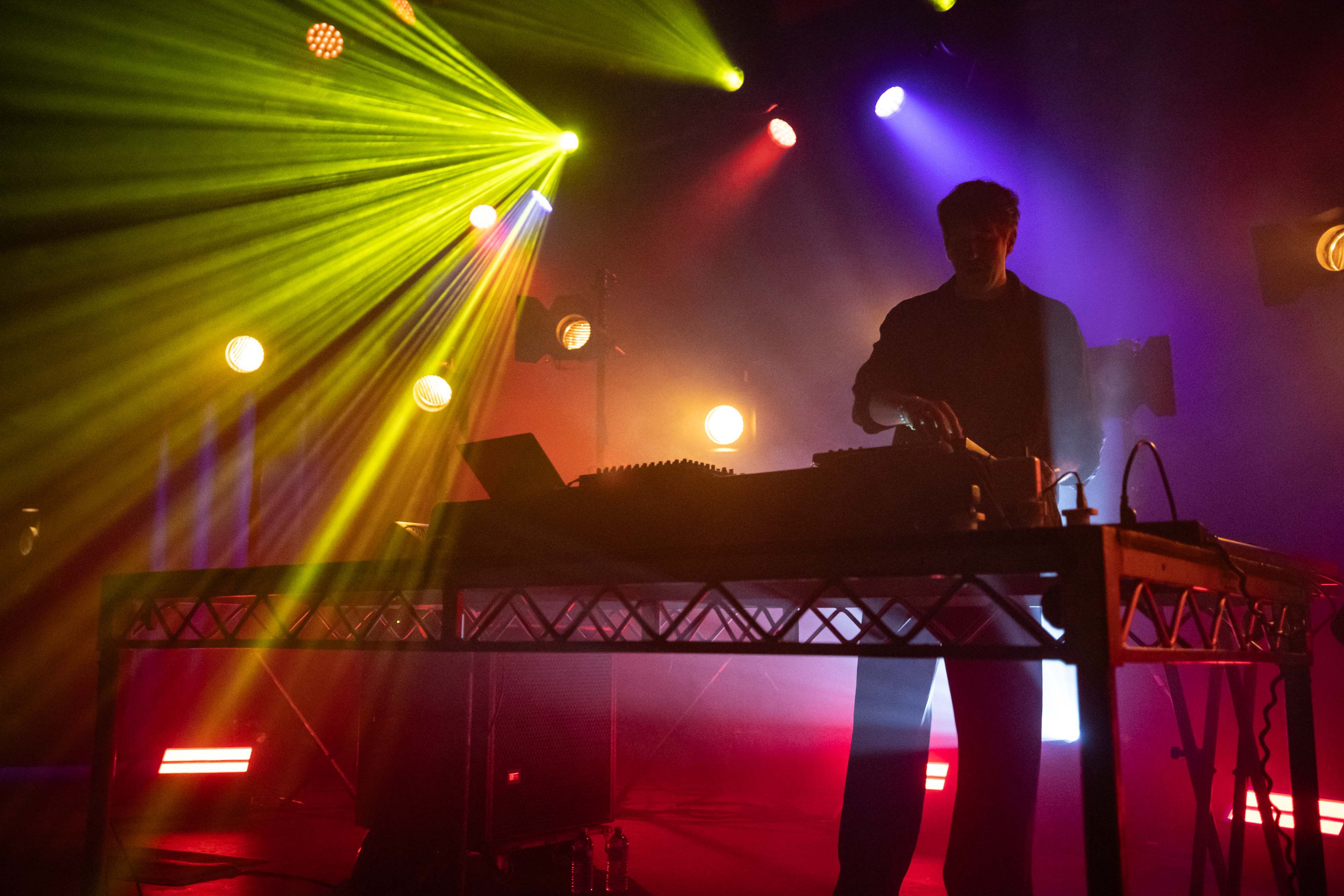 Yellow, purple and red lights backlight Christian Löffler on the stage of the Commodore Ballrom