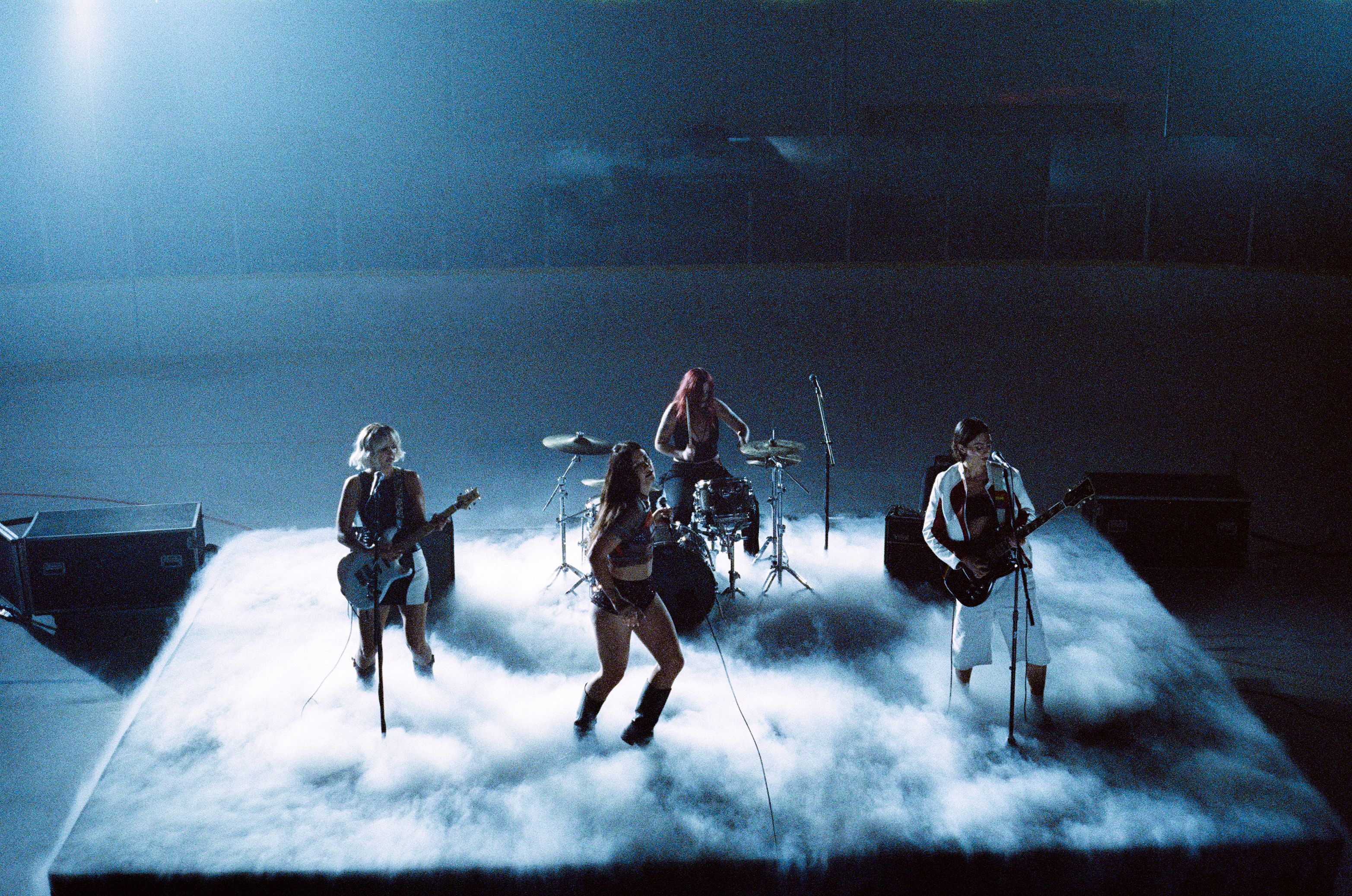 The Beaches perform on a misty stage in the "Edge of the Earth" music video.