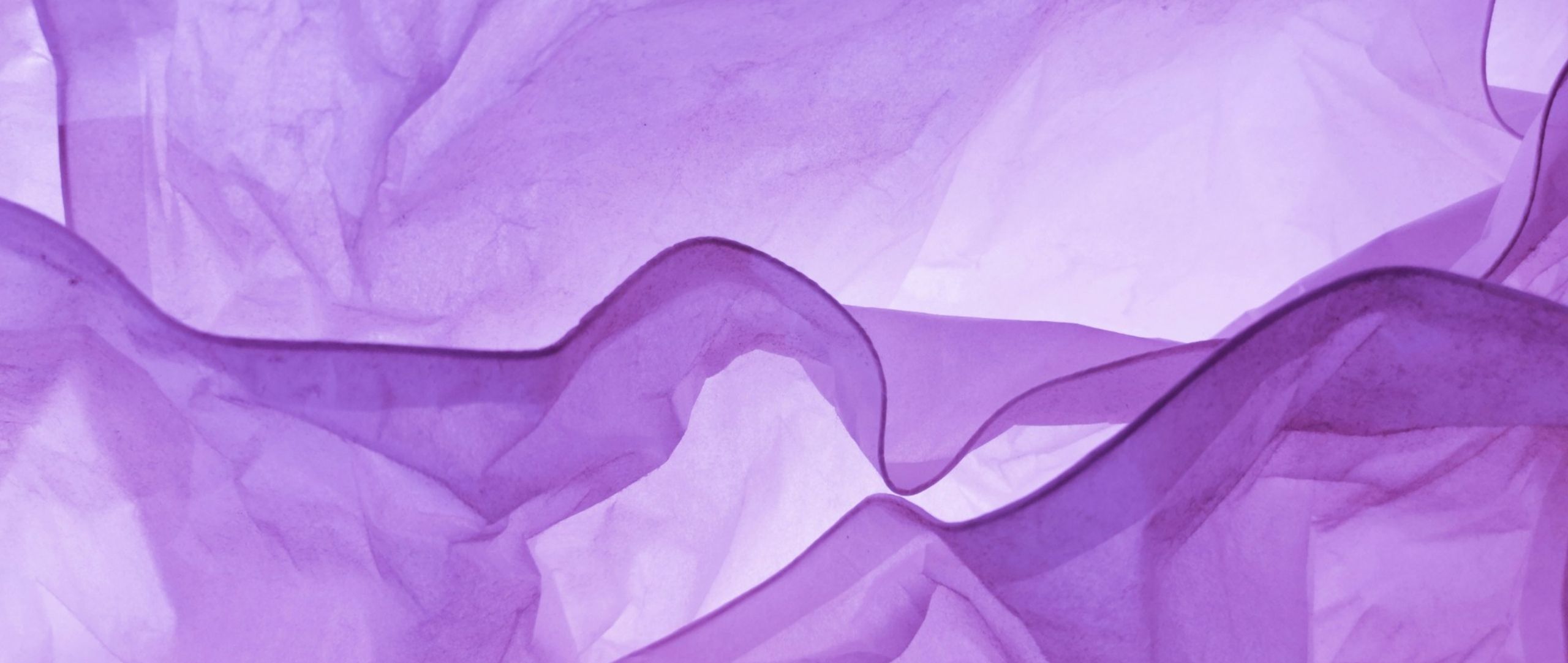 Abstract backlit folds of purple tissue paper