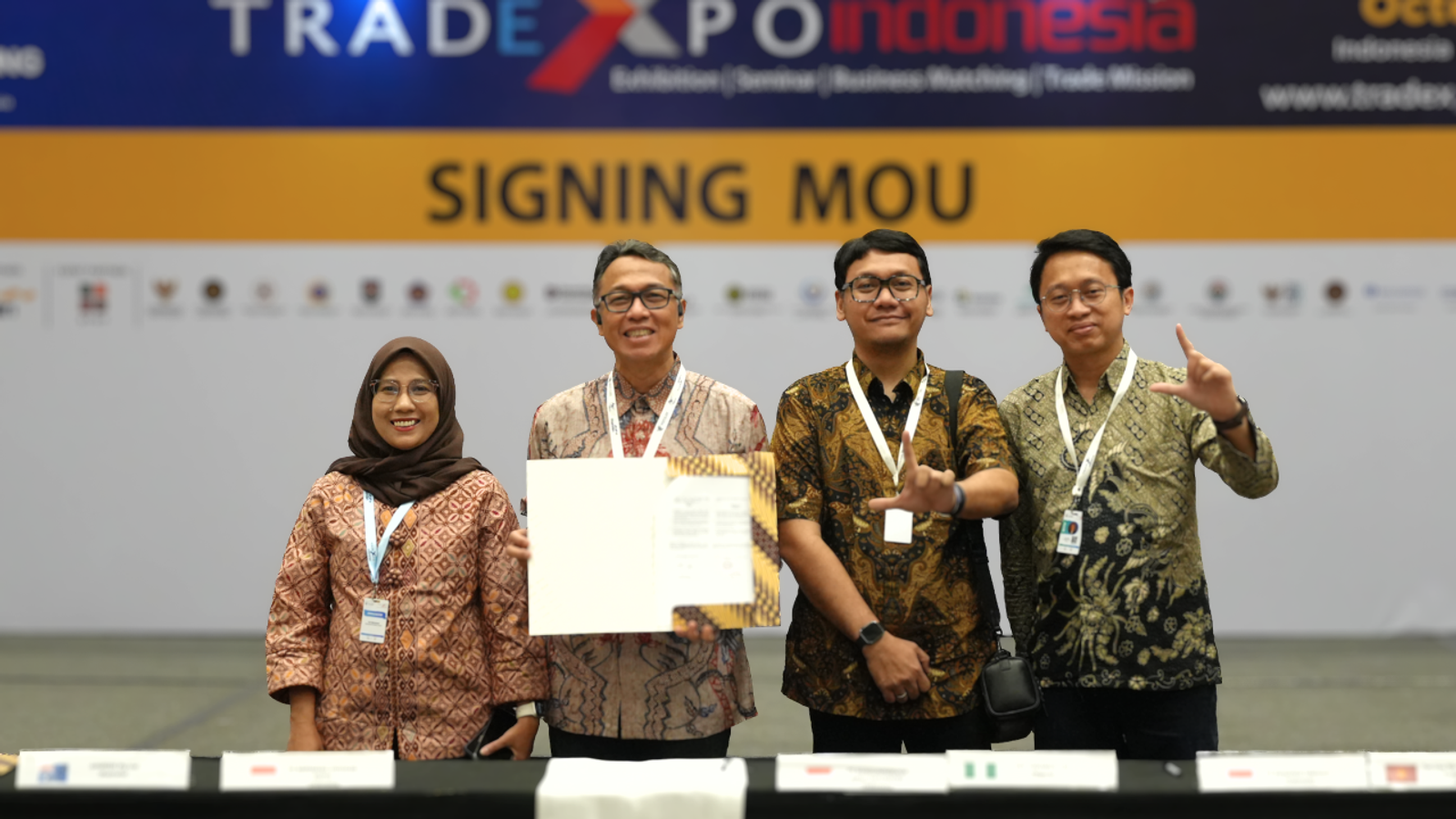 Four representatives at an MOU signing ceremony at Trade Expo Indonesia