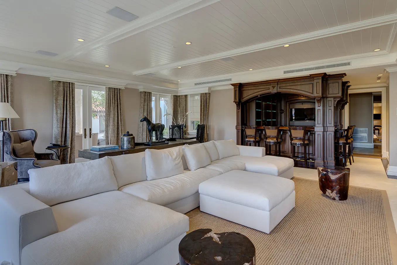 Sophisticated living room with built-in wet bar, custom millwork, and elegant furnishings