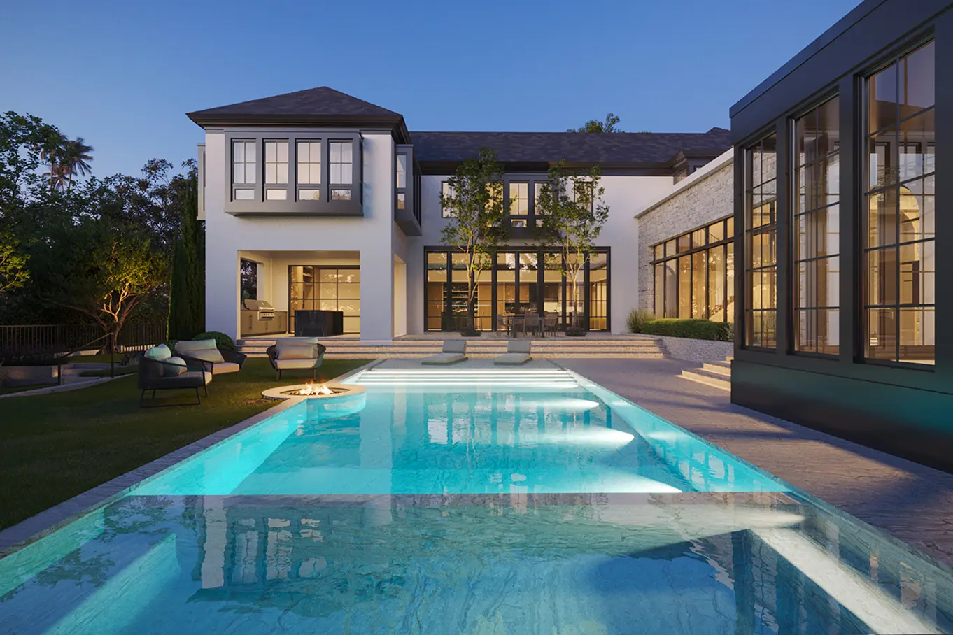 Twilight view of resort-style pool with fire pit, lounge seating, and illuminated Mediterranean-style residence