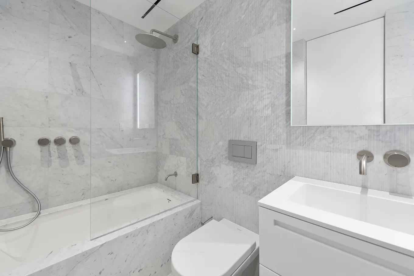 Luxurious bathroom with marble finishes, contemporary fixtures, and elegant design details