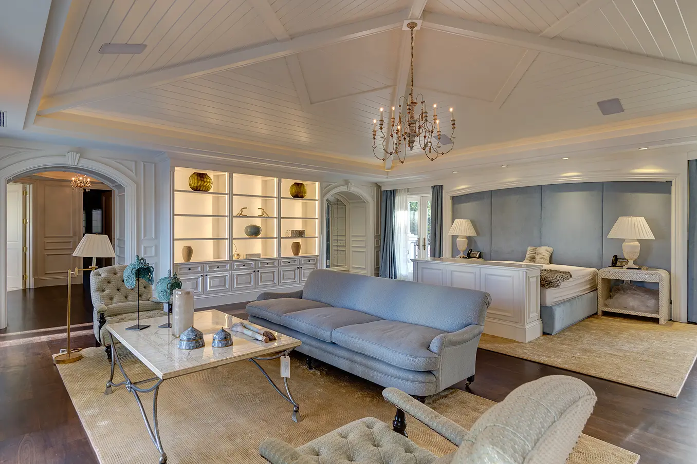Spacious master bedroom with sitting area, neutral tones, and luxurious appointments