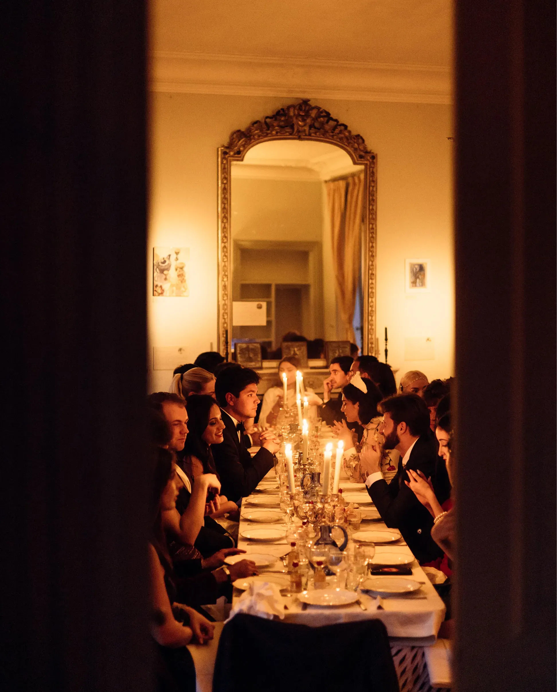 Club members dining around a table, engaged in conversation.