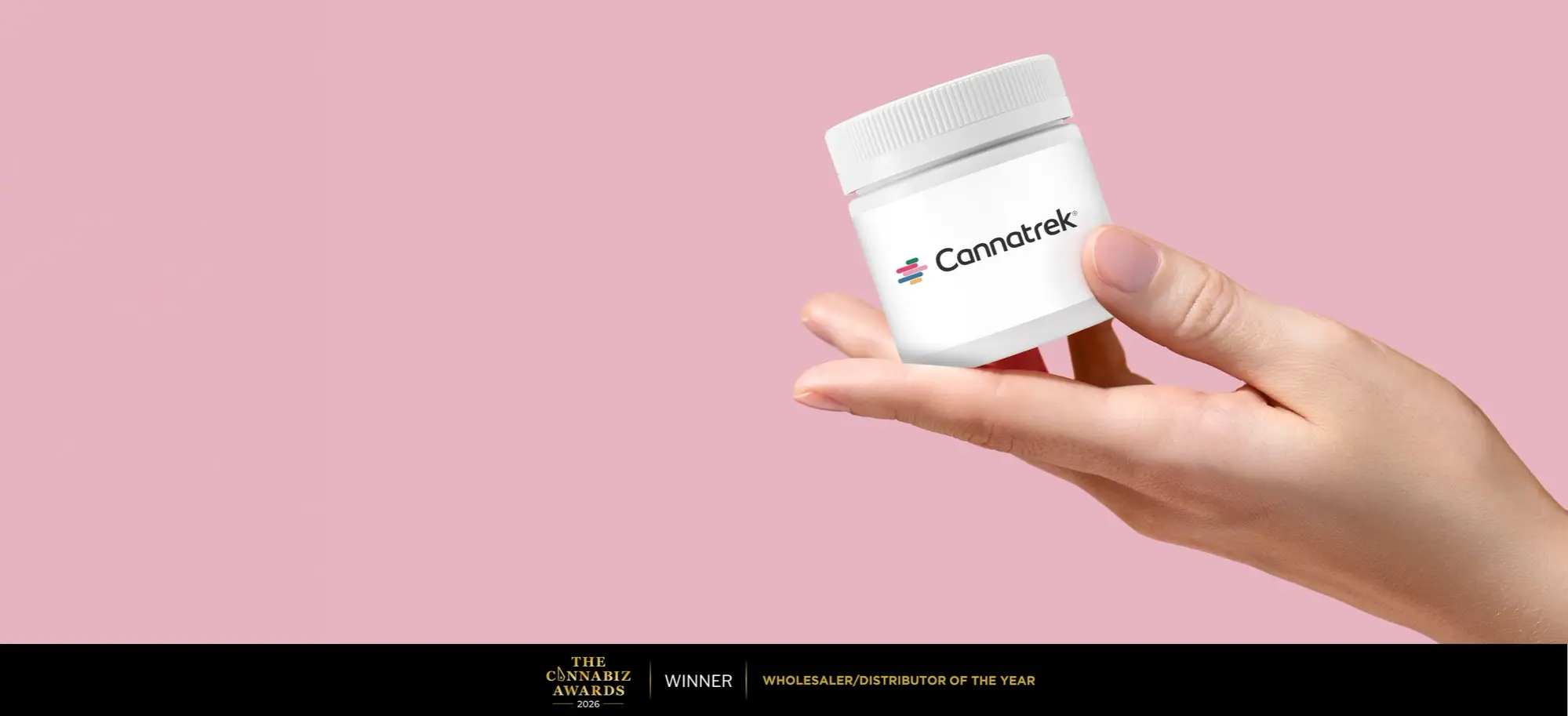 A hand holding a container labelled with "Cannatrek".