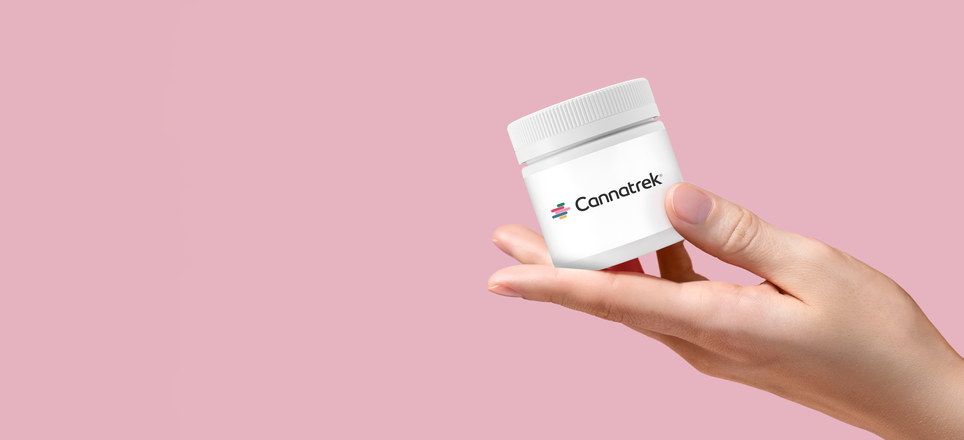 A hand holding a container labelled with "Cannatrek".