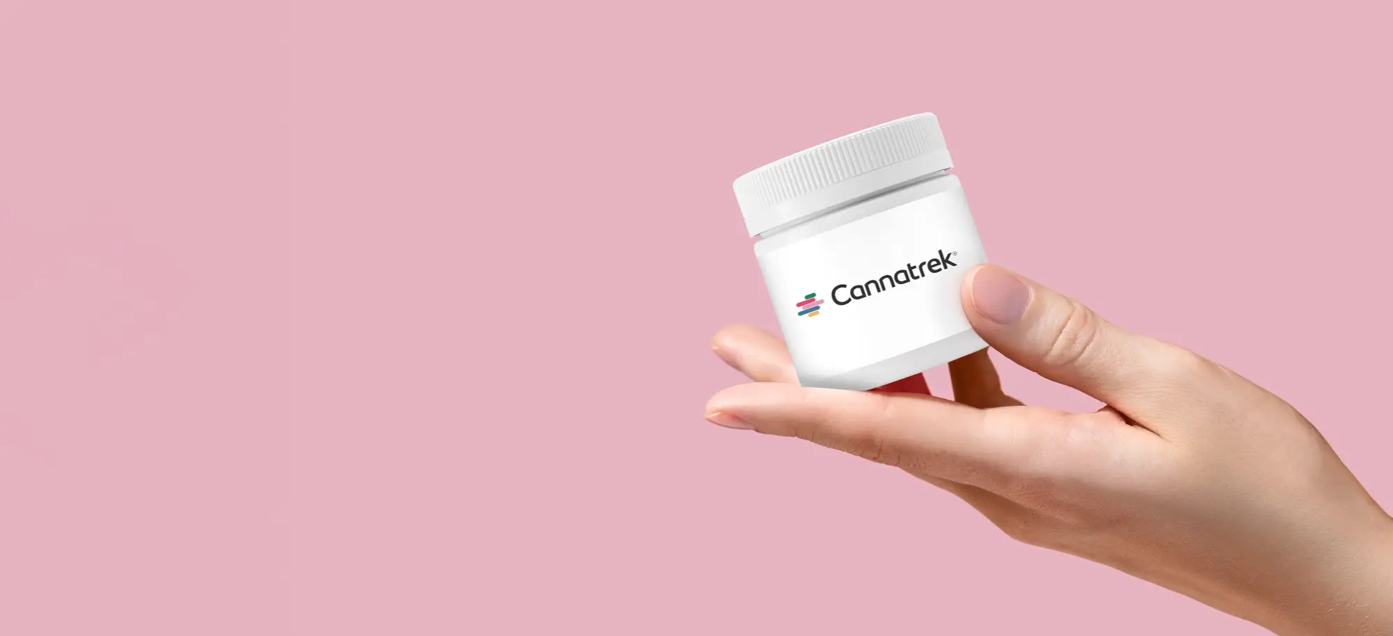 A hand holding a container labelled with "Cannatrek".