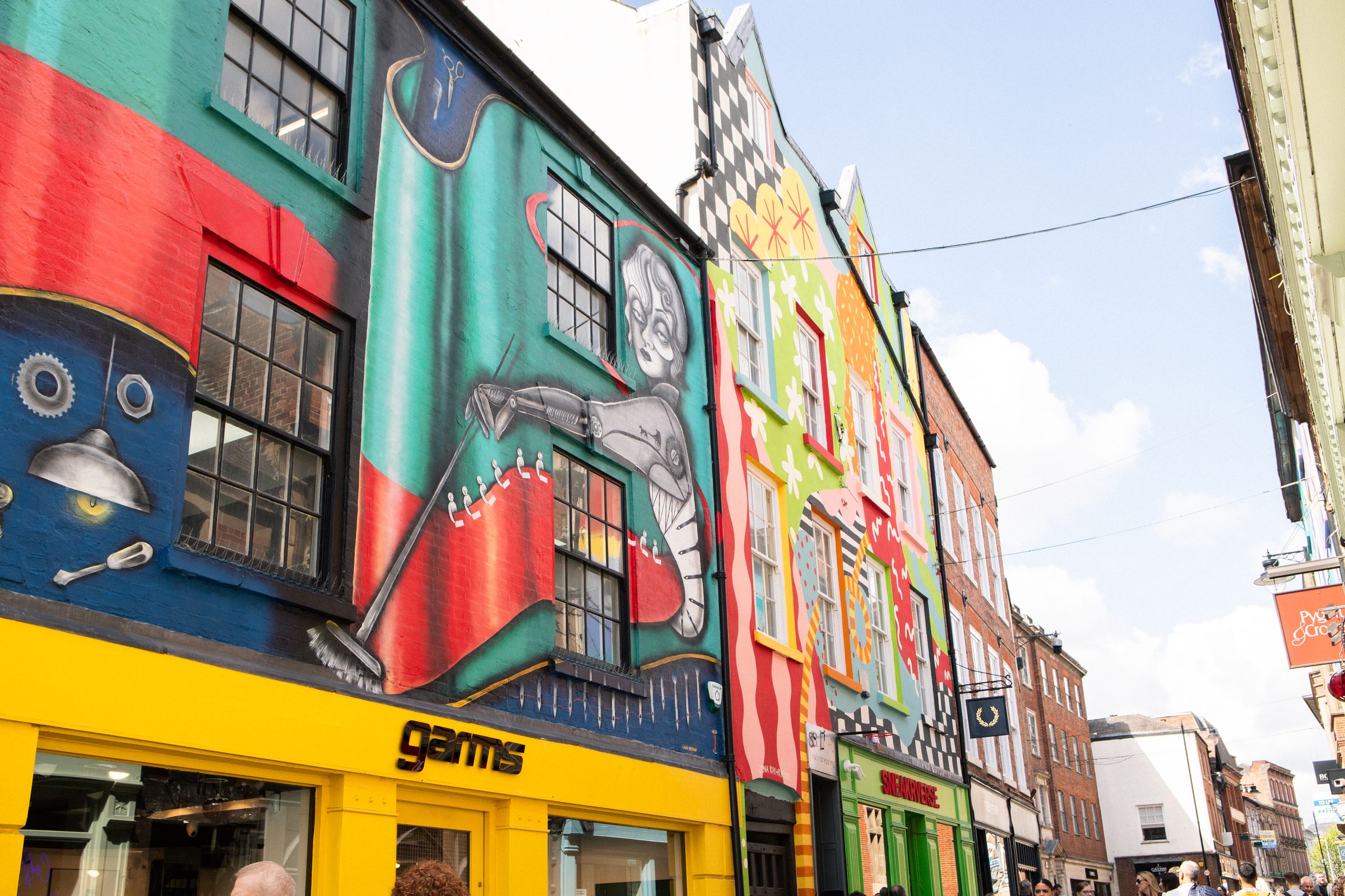 Bright murals above shops on Bridlesmith Gate, Nottingham