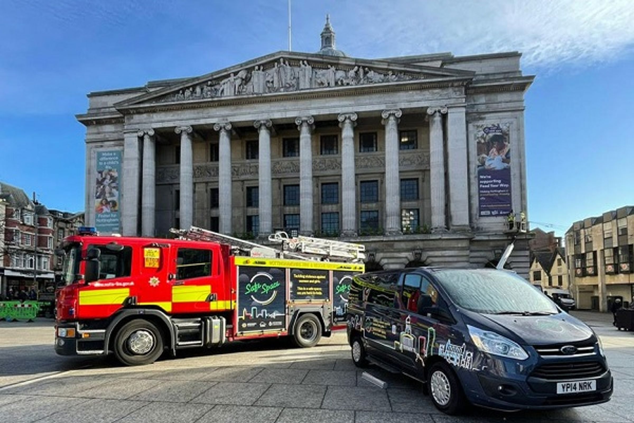 A fire engine and van with Safe Space logos, parked in front of Nottingham Council House on Old Market Square