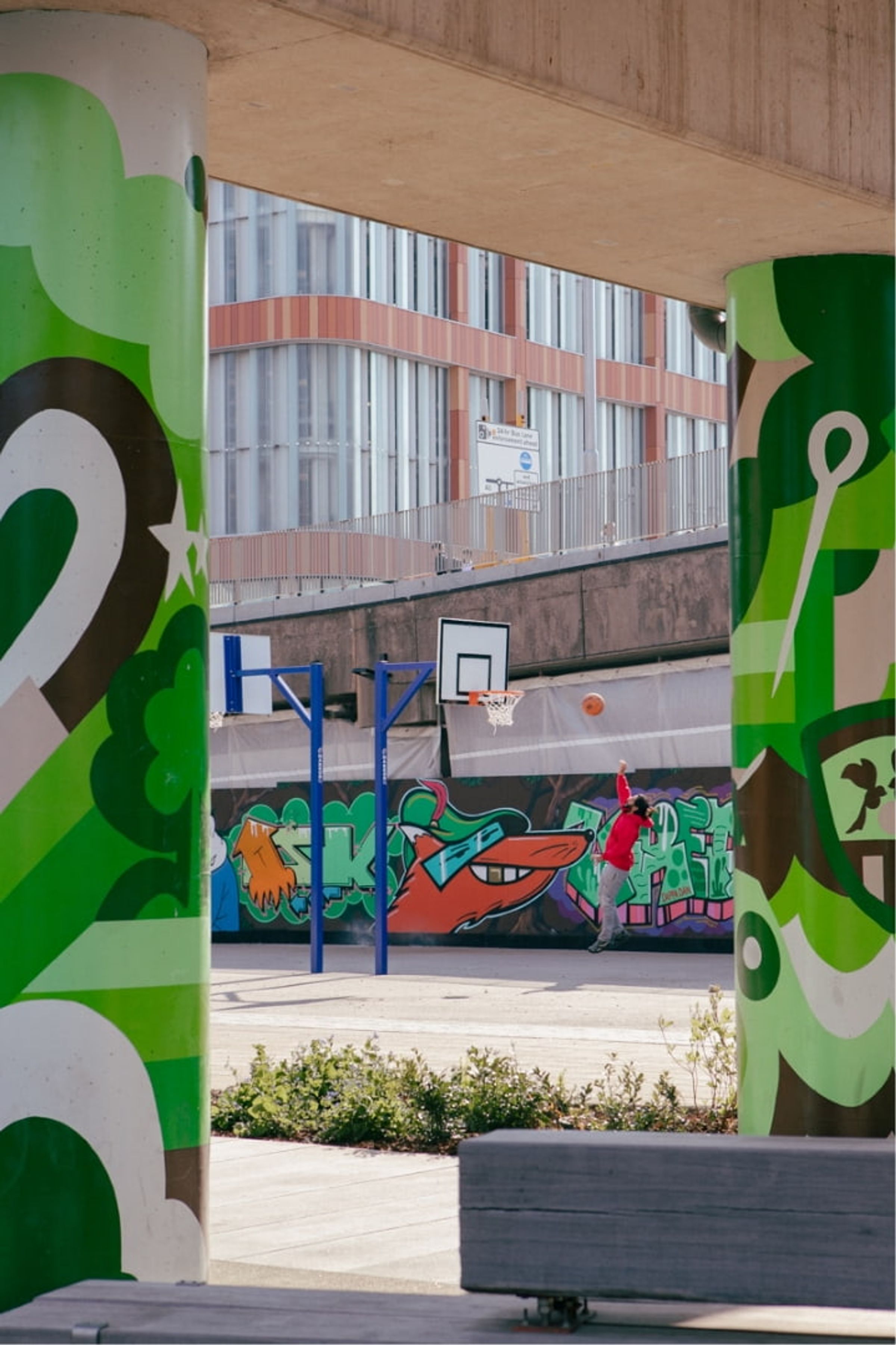 Someone shooting hoops on a basketball court outside Broadmarsh Car Park, Nottingham