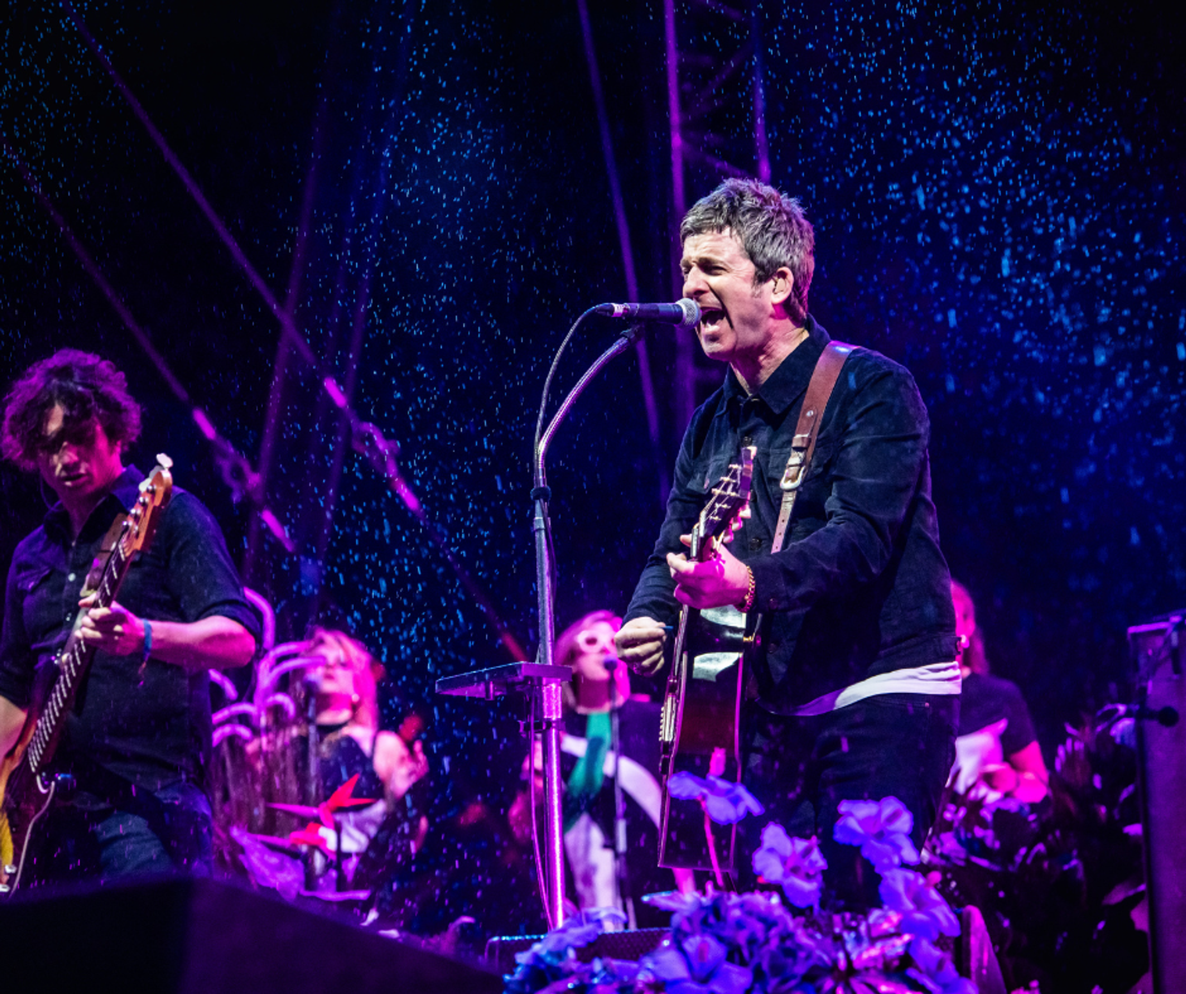 Noel Gallagher on stage singing with his High Flying Birds band