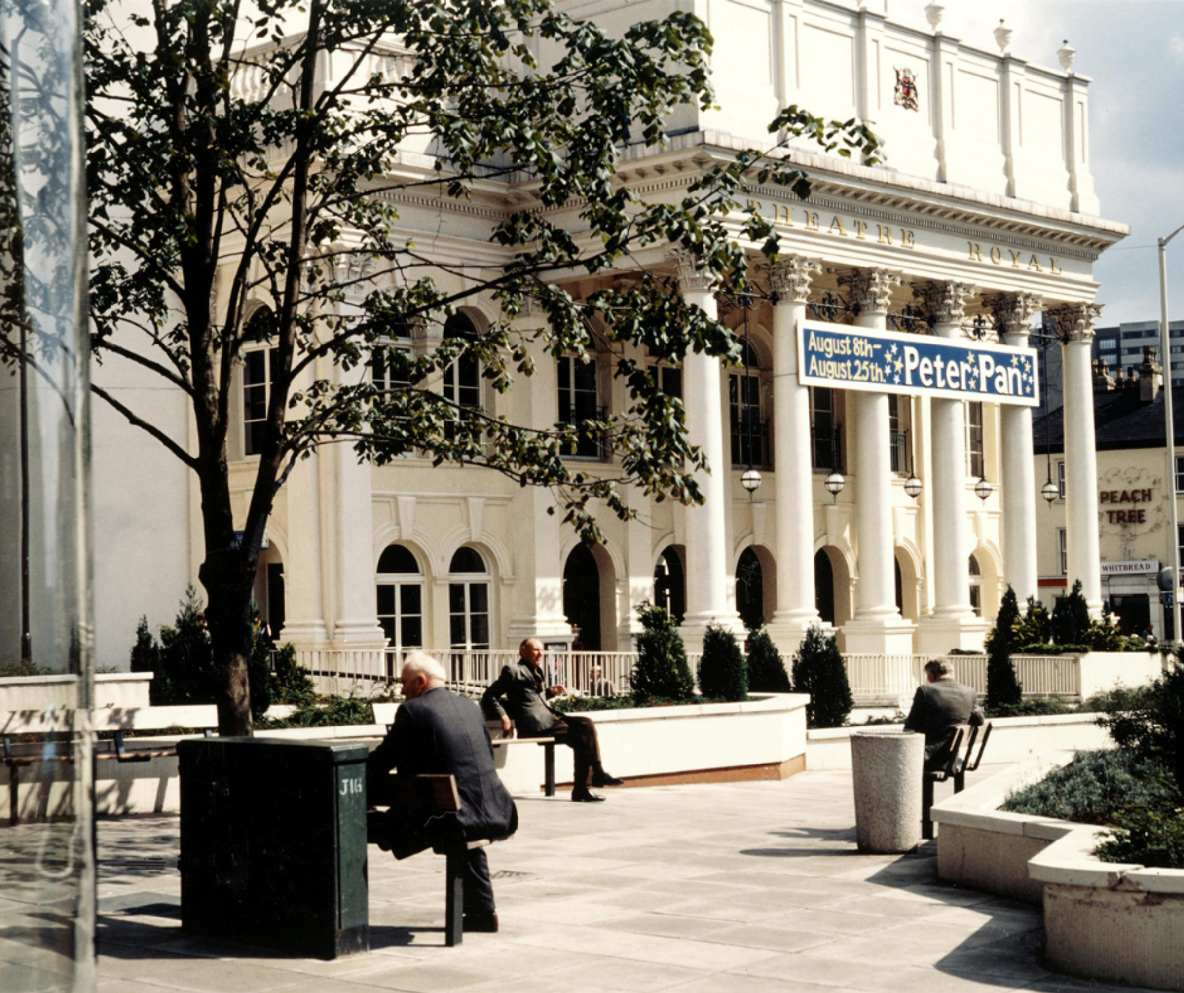 The outside of Nottingham's Theatre Royal in the sunshine, with a banner advertising a production of Peter Pan
