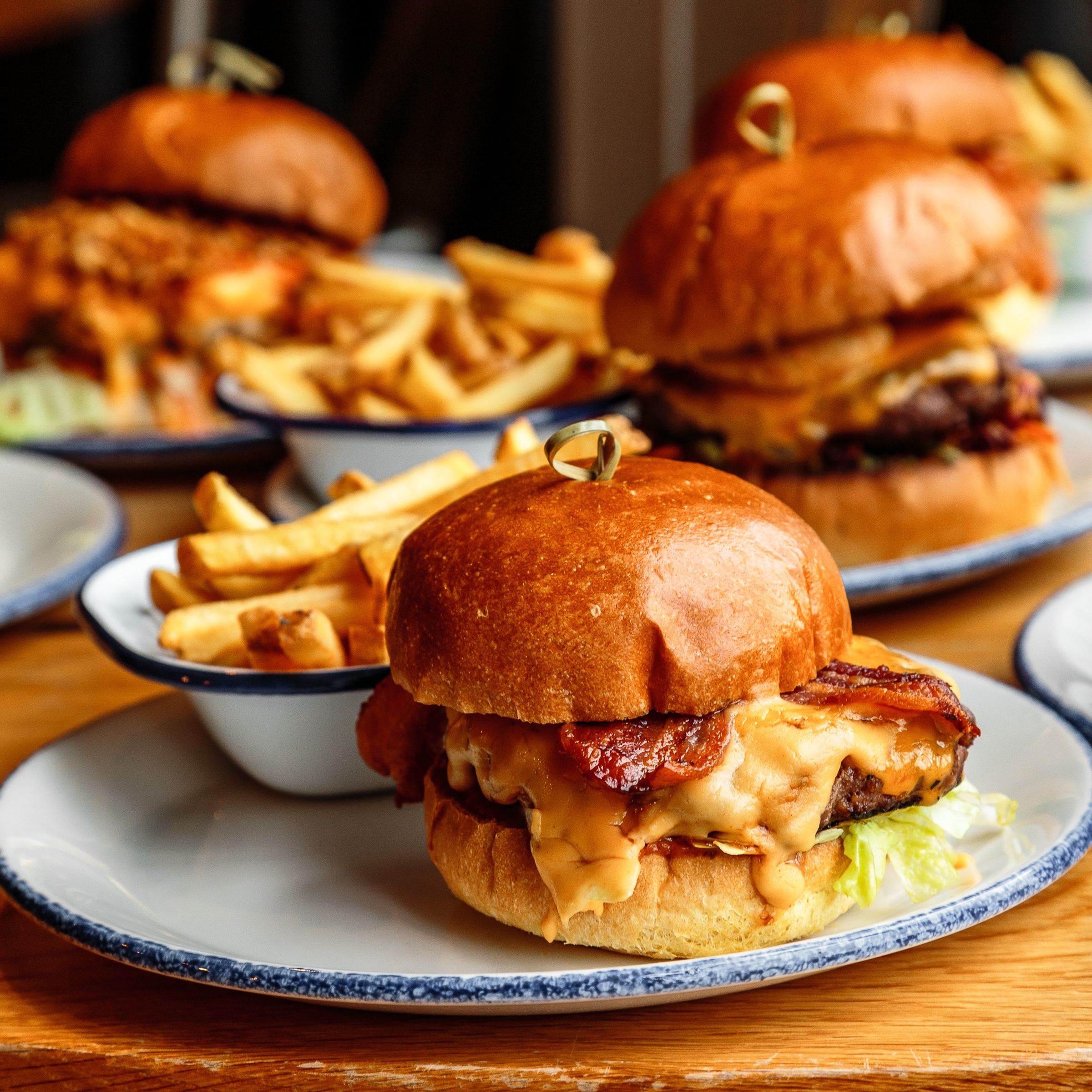 A table covered in burgers and chips