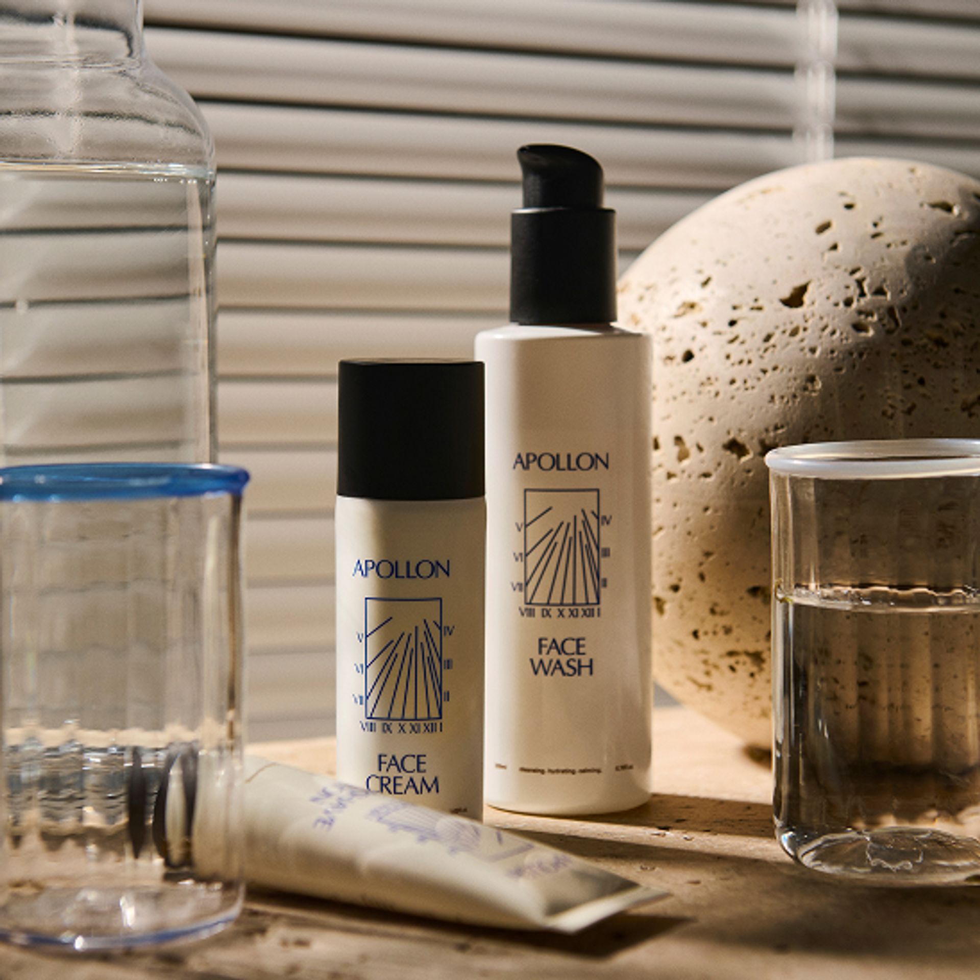 Apollon Studios men's skincare range on travertine in natural light — a buyer's guide to the best men's skincare in Denmark