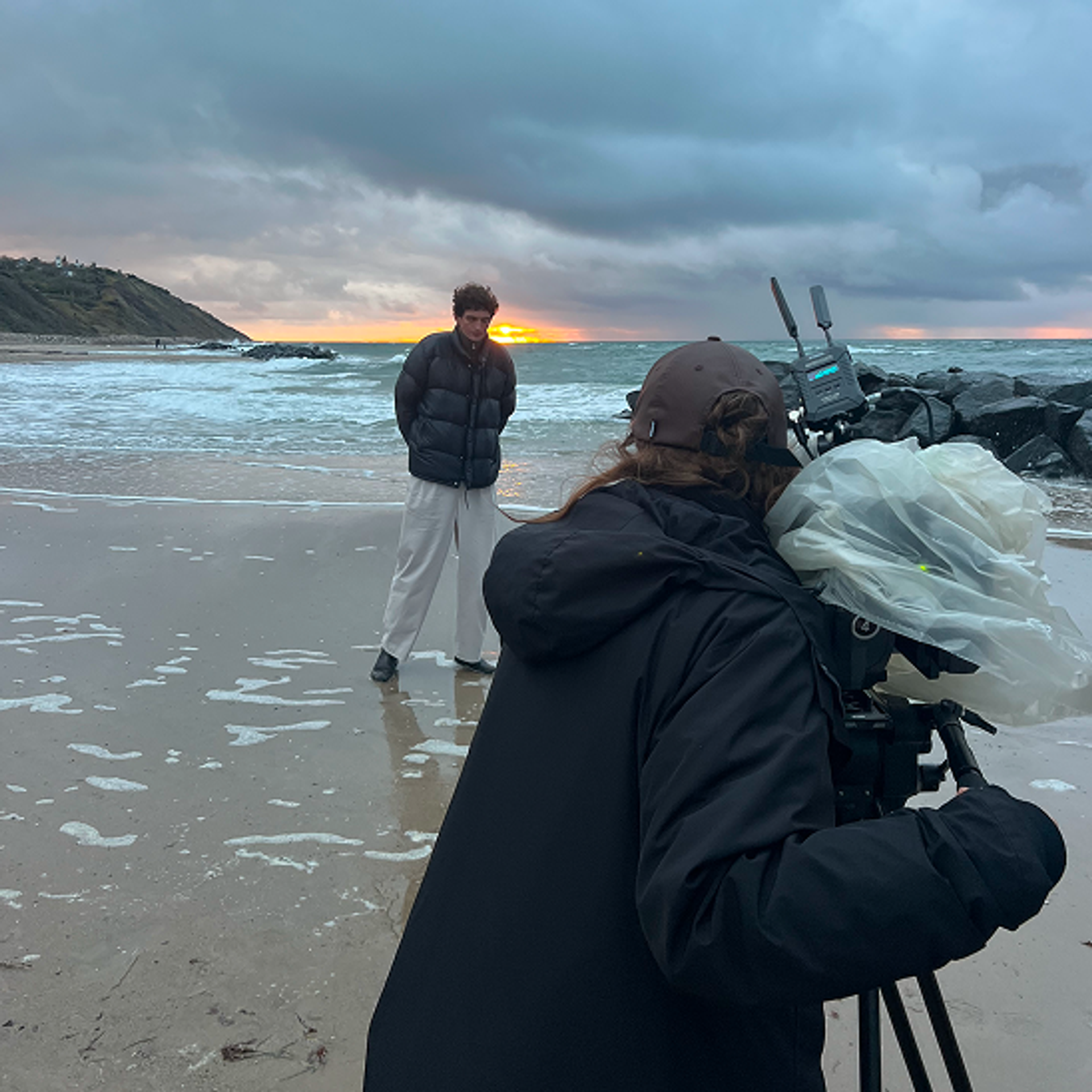 Model and photographer on the beach in natural sunset - editorial image for Apollon Studios brand film