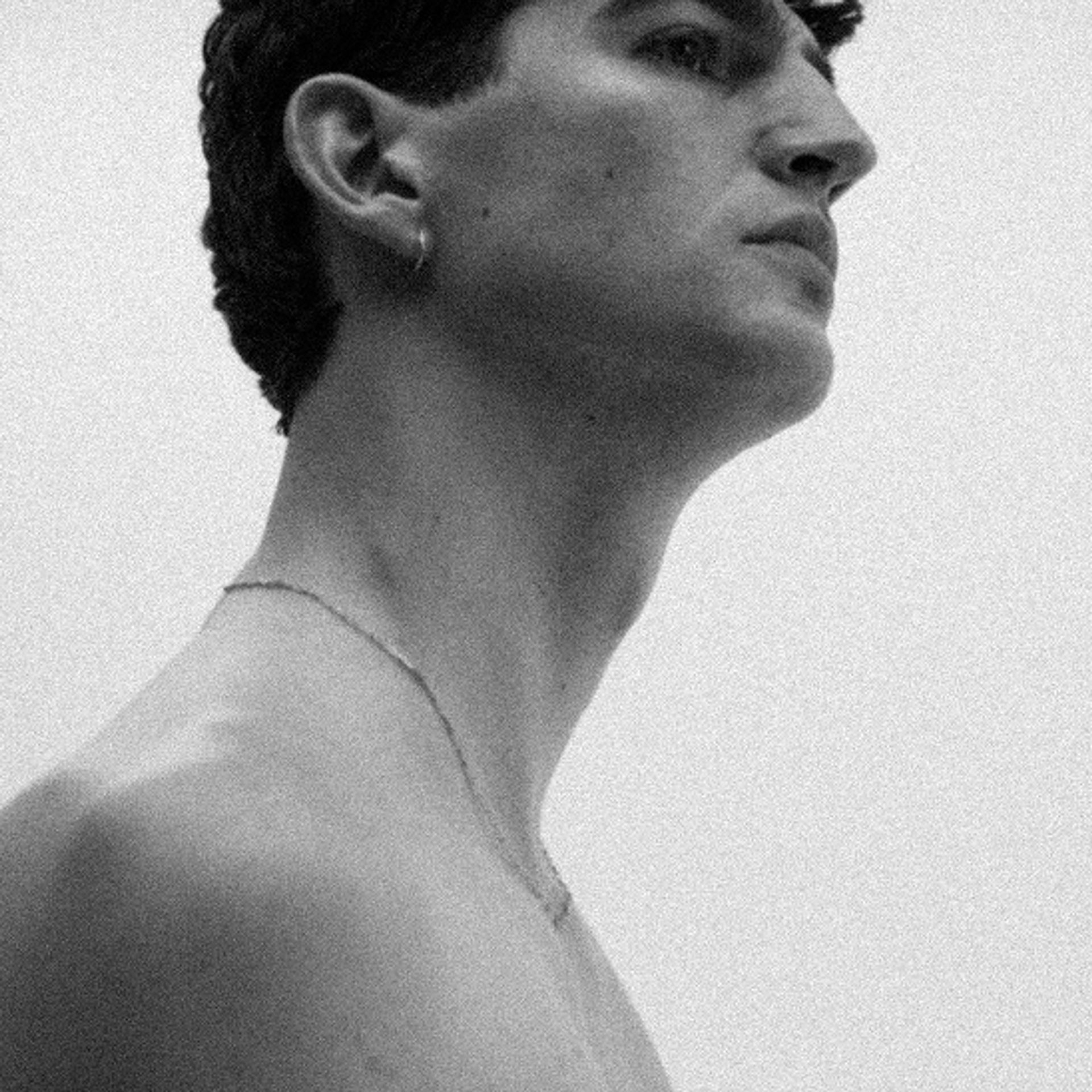 Black-and-white profile portrait of a man with clear, healthy skin — men's face serum guide by Apollon Studios