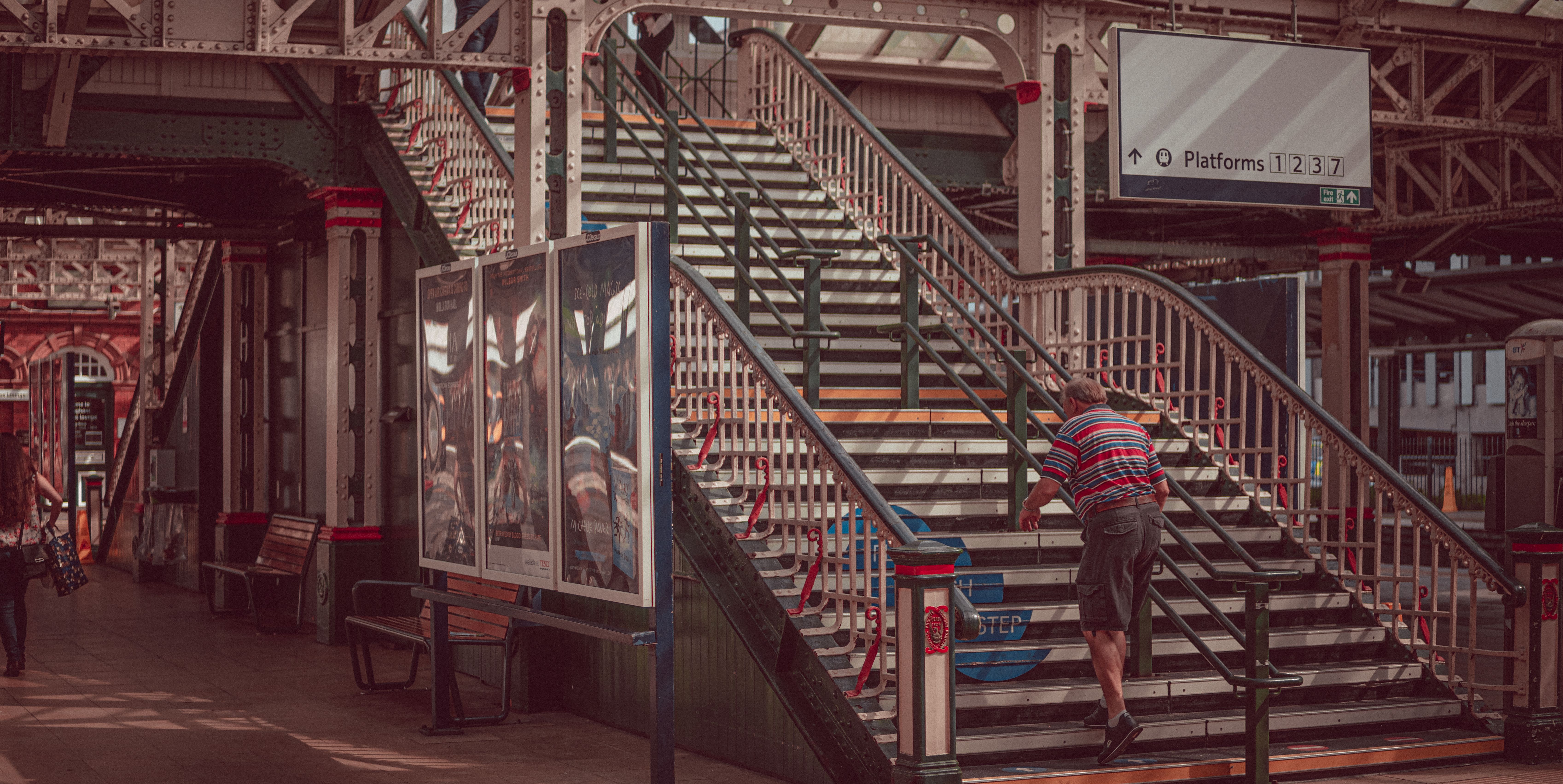 Elderly man climbing the stairs of Nottingham Train Station