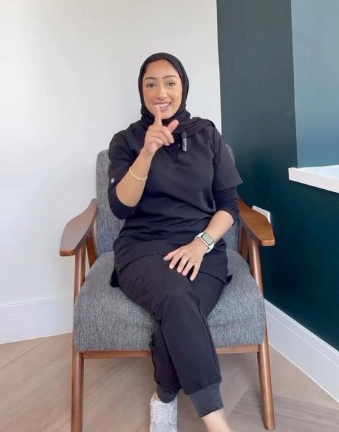 Dr Zoya Ahmed, cosmetic dentist, seated in her clinic
