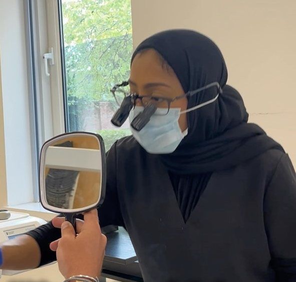 Dr Zoya Ahmed working in magnification loupes