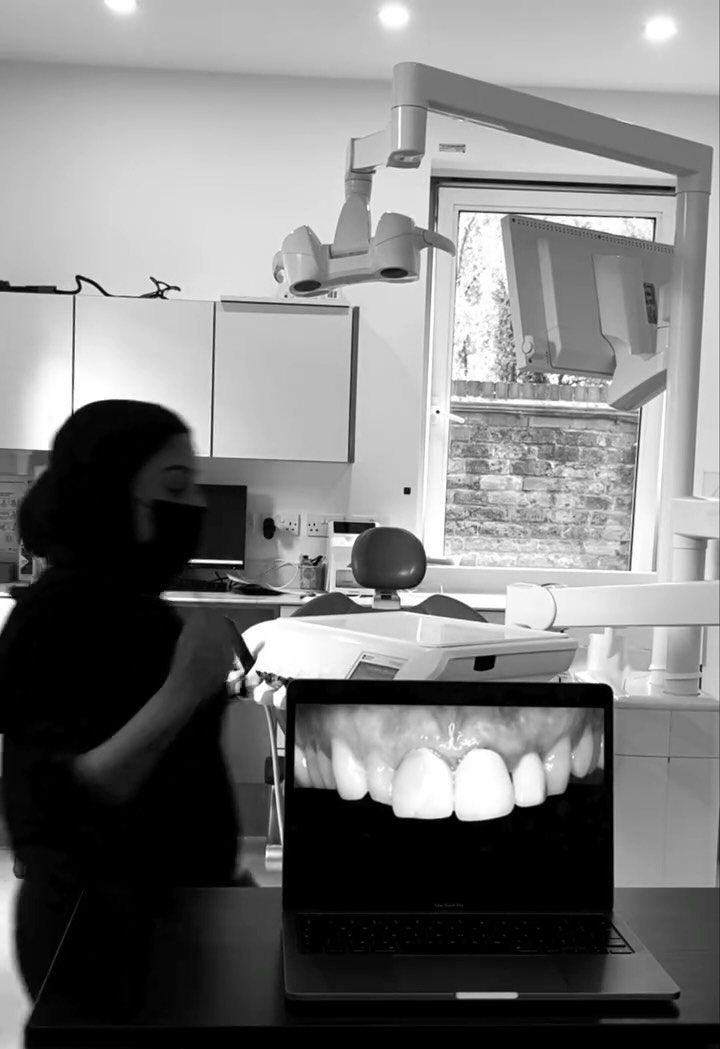 Dr Zoya reviewing a digital smile photograph in the clinic