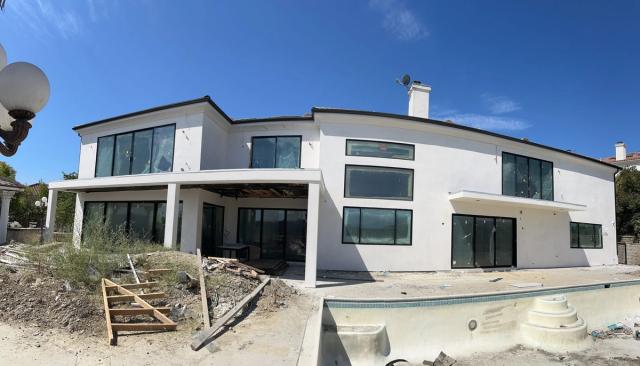Whole-home remodel in progress, rear elevation & pool