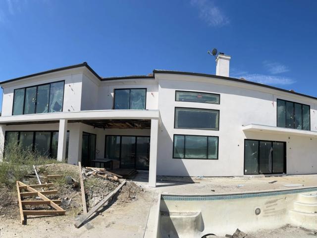 Whole-home remodel in progress, rear elevation & pool
