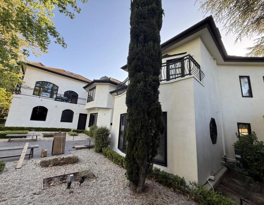 Finished residential re-stucco, white two-story home