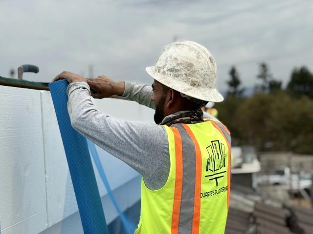 Crew installing foam parapet mesh — Duarte's Plastering project near Lakewood, CA