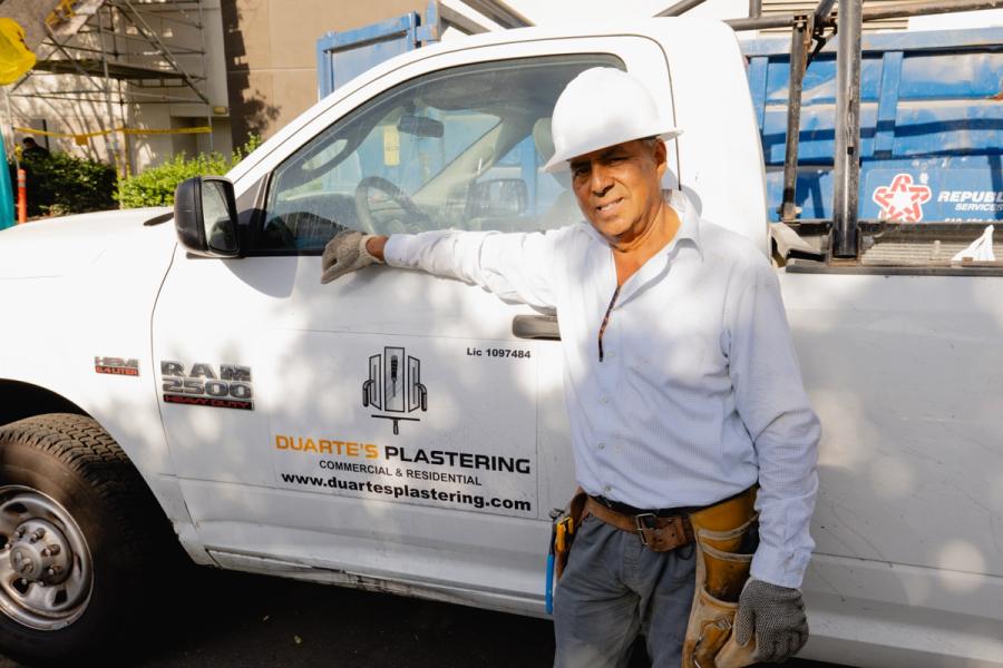 Omar Duarte, owner of Duarte’s Plastering, beside his branded work truck