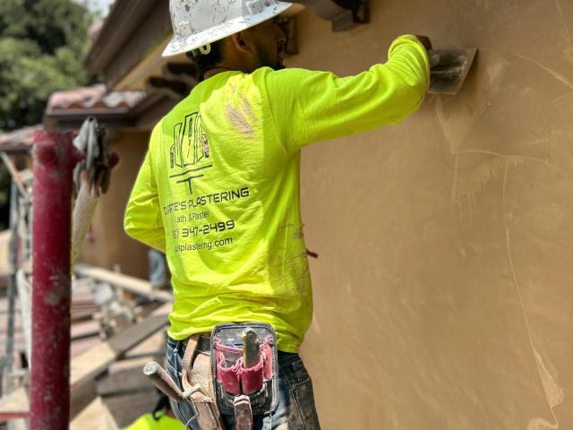 Plasterer smoothing a finish coat — Duarte's Plastering project near Irvine, CA