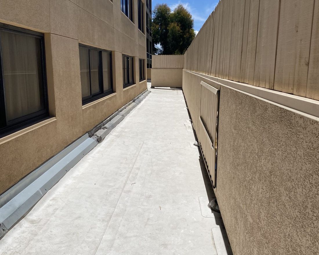 Commercial side elevation, fresh finish coat — Duarte's Plastering project near San Diego, CA