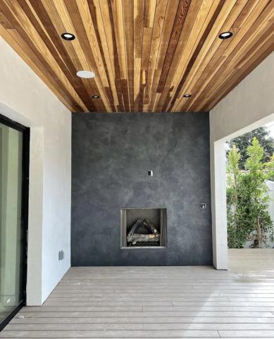 Design-build fireplace, plaster and wood slat ceiling