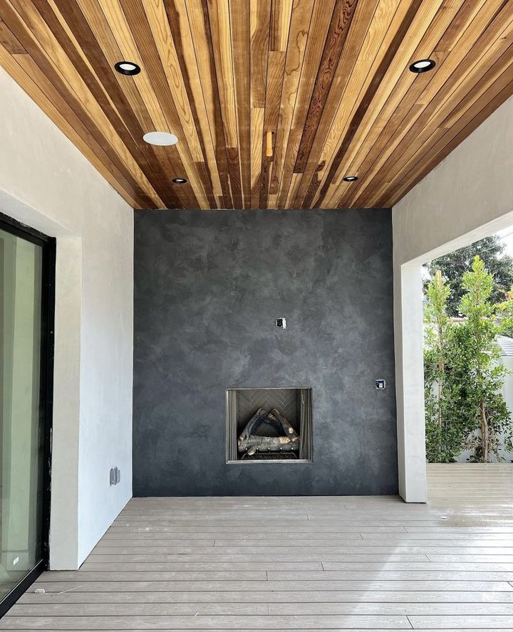 Design-build fireplace, plaster and wood slat ceiling