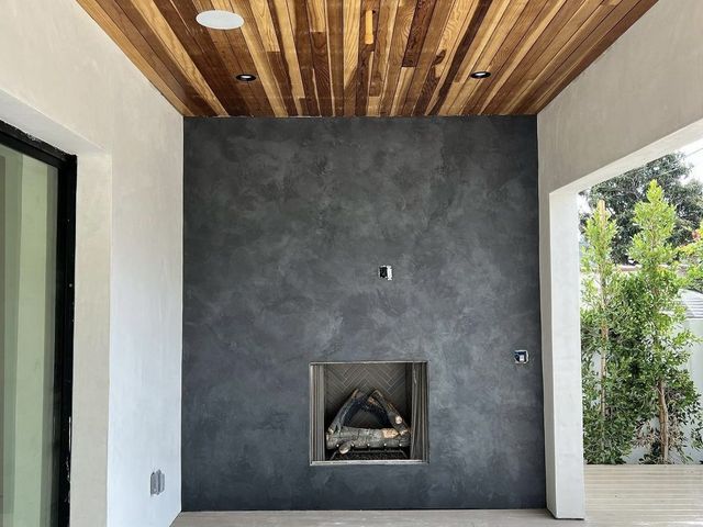 Design-build fireplace, plaster and wood slat ceiling