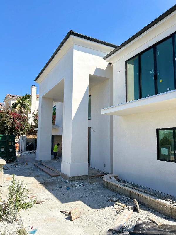 Smooth stucco at a grand two-story entry